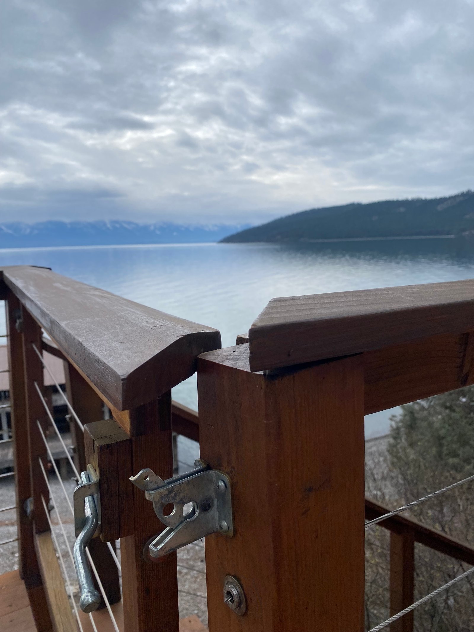 Before photo of deck gate latch and railing by the lake